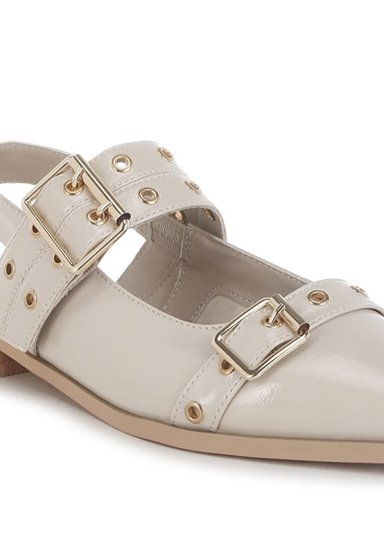 Beige flats with a pointed toe, adjustable buckle straps, eyelet detailing, and a slingback design. Features a cushioned insole and 1-inch flat heel for comfort.