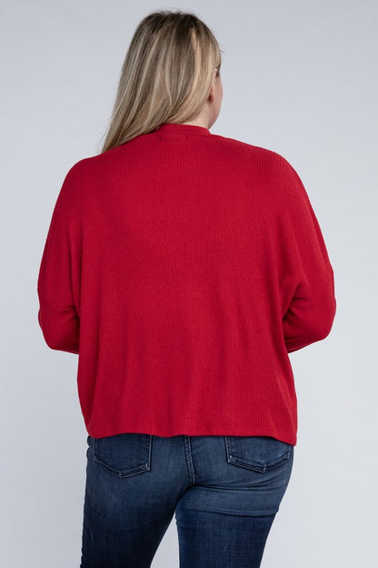 Plus size model wearing Raya Curvy Plus Drop Shoulder Top in red with mock neck, back view.