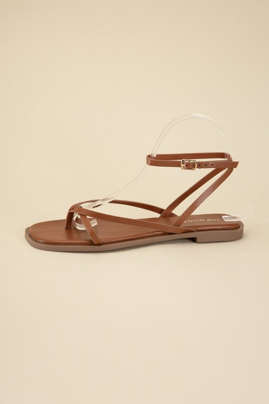 Tan stylish strappy flat sandals with an open toe and square shape.