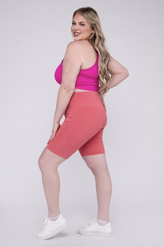 High-rise plus-size athletic biker shorts in desert rose, featuring a fitted silhouette and seamless design for comfort and flexibility.