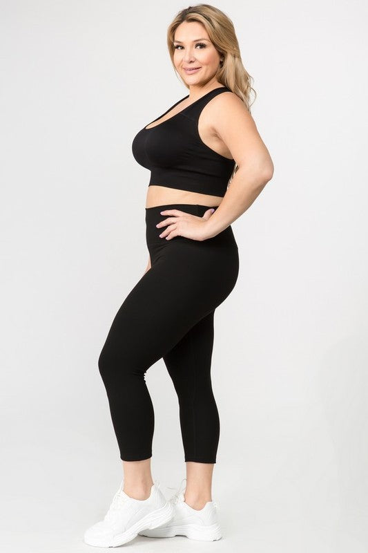 Black high-rise capri leggings with a soft feel, wide waistband, and hidden pocket for essentials. Made with stretchy fabric.