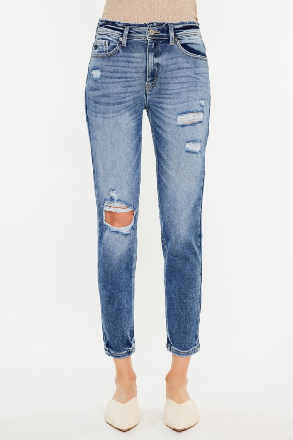 Medium wash high-rise mom jeans with distressed details and slightly stretchy fabric, offering a vintage-inspired, comfortable fit.