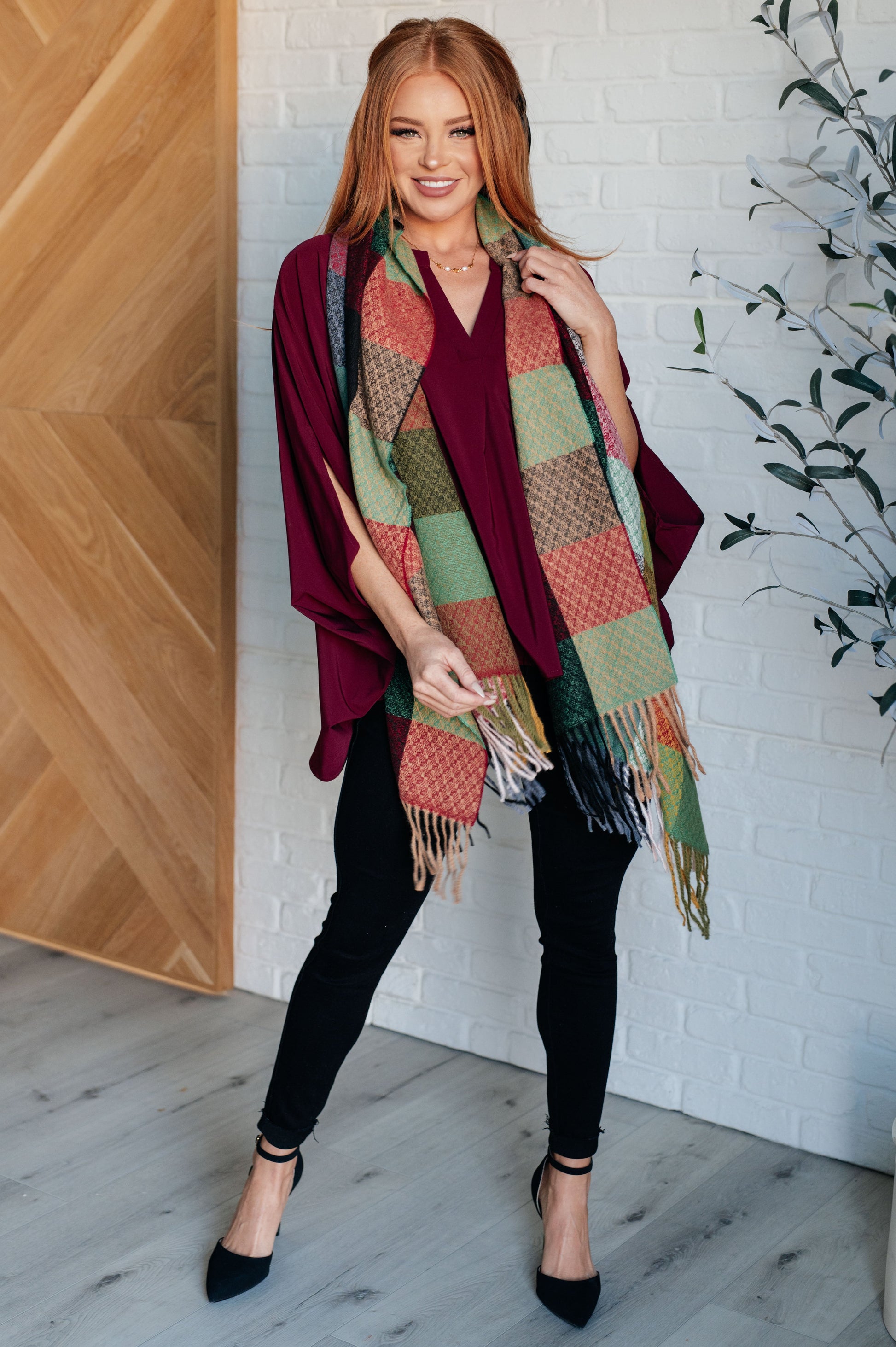 Women's cozy checkered fringe scarf in multicolor shades, made from warm brushed fabric with playful fringe. Versatile for layering as a scarf or shawl to elevate any outfit.