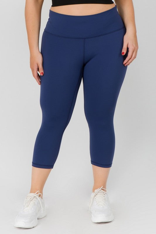 Navy high-rise capri leggings with a soft feel, wide waistband, and hidden pocket for essentials. Made with stretchy fabric.