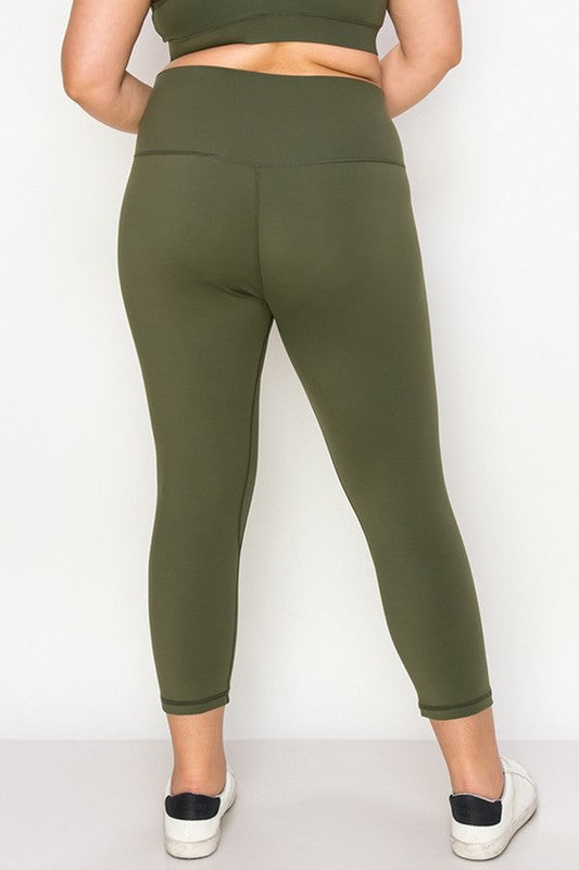 Army green high-rise capri leggings with a soft feel, wide waistband, and hidden pocket for essentials. Made with stretchy fabric.