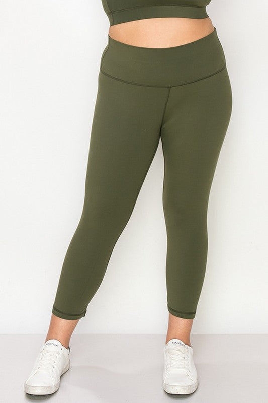 Army green high-rise capri leggings with a soft feel, wide waistband, and hidden pocket for essentials. Made with stretchy fabric.