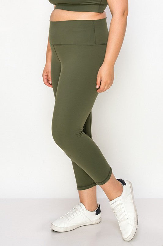 Army green high-rise capri leggings with a soft feel, wide waistband, and hidden pocket for essentials. Made with stretchy fabric.