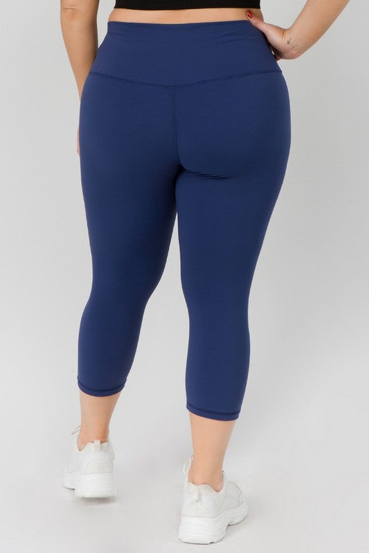 Navy high-rise capri leggings with a soft feel, wide waistband, and hidden pocket for essentials. Made with stretchy fabric.