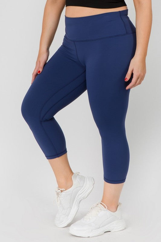 Navy high-rise capri leggings with a soft feel, wide waistband, and hidden pocket for essentials. Made with stretchy fabric.