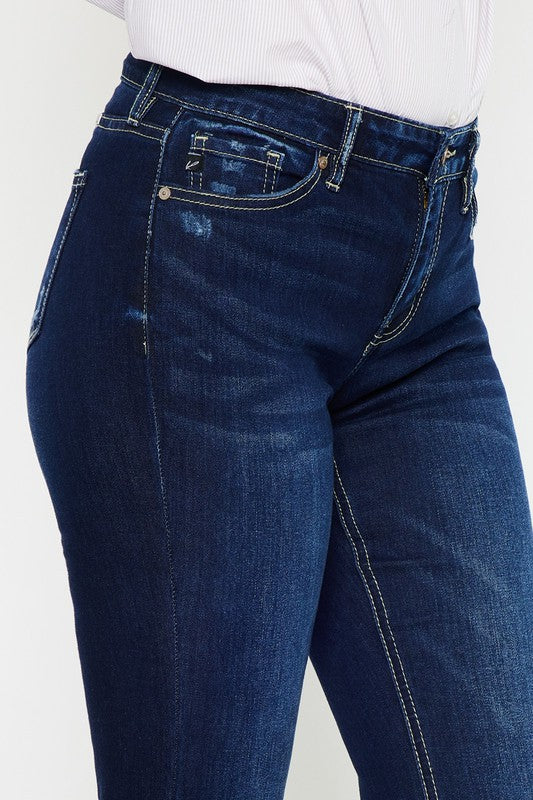 Front close up of the KanCan USA Hester Mid Rise Hem Detail Flare Jeans in dark wash, featuring a button closure, flared leg silhouette, and stylish hem detailing.