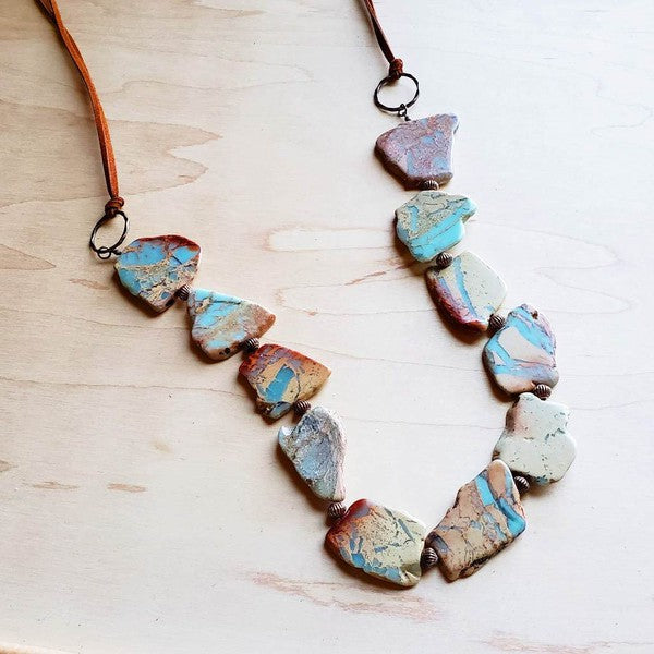 Handcrafted necklace featuring genuine variegated stones with unique patterns, adjustable from 30" to 36" with a self-tie leather closure