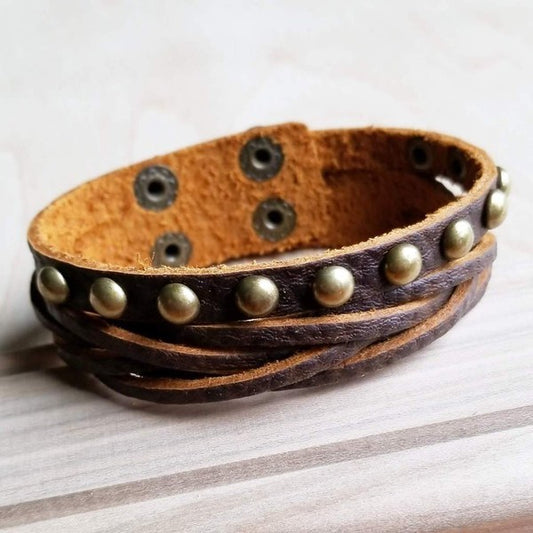 Brown leather cuff bracelet with antique gold studs, featuring multiple strands and adjustable snap closures.