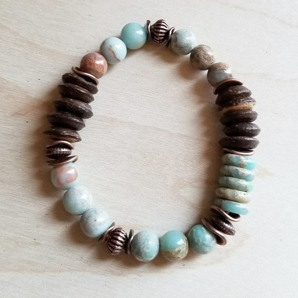 A multi-strand stretch bracelet featuring Aqua Terra gemstones and natural wood beads, ranging from 8-10mm in size. Handcrafted for a unique, earthy look.