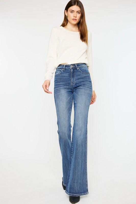 Medium stone wash high-rise flare jeans with pockets, a button closure, and a long length silhouette.