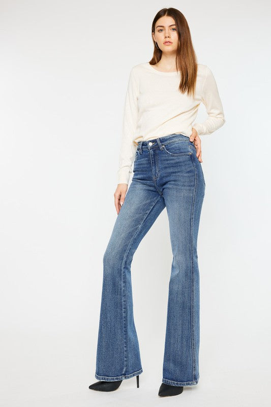 Medium stone wash high-rise flare jeans with pockets, a button closure, and a long length silhouette.