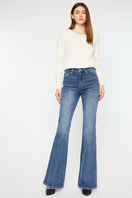 Medium stone wash high-rise flare jeans with pockets, a button closure, and a long length silhouette.