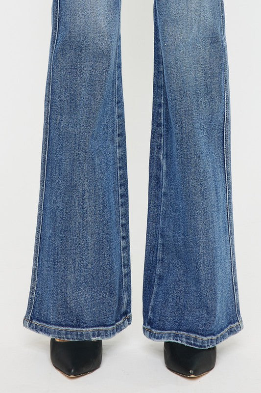 Medium stone wash high-rise flare jeans with pockets, a button closure, and a long length silhouette.