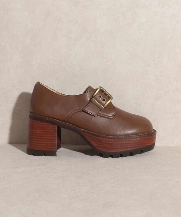 Brown buckled platform loafers with e-inch heel, 1.5-inch front platform, and buckle closure.