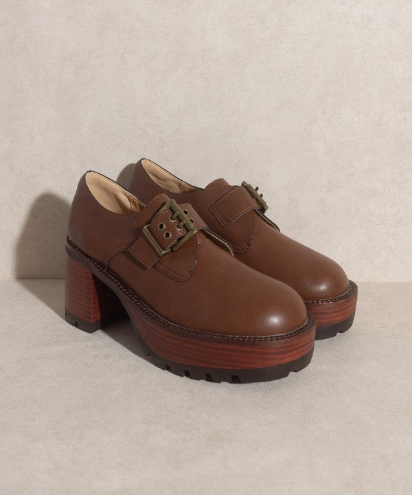 Brown buckled platform loafers with e-inch heel, 1.5-inch front platform, and buckle closure.