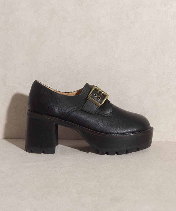 Black buckled platform loafers with e-inch heel, 1.5-inch front platform, and buckle closure.