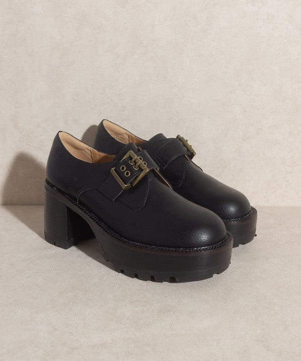 Black buckled platform loafers with e-inch heel, 1.5-inch front platform, and buckle closure.