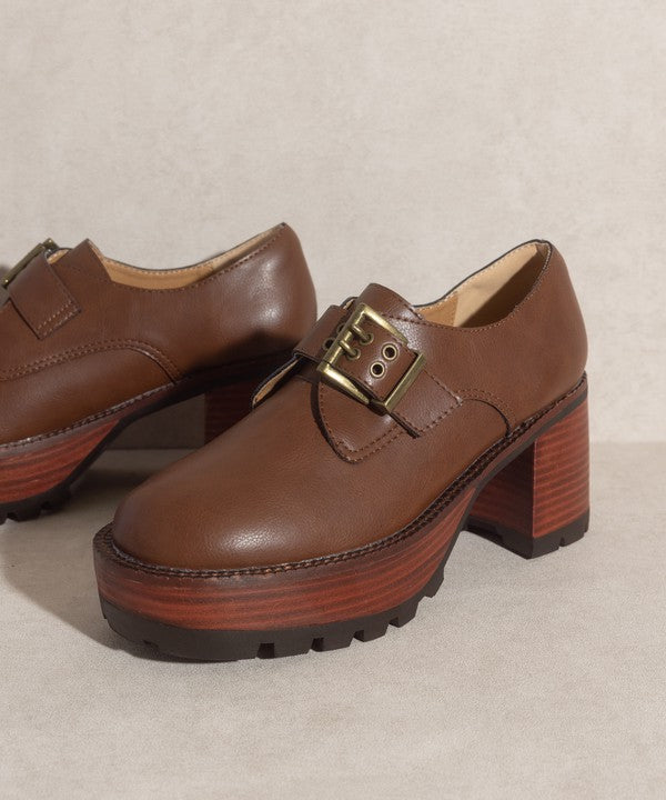 Brown buckled platform loafers with e-inch heel, 1.5-inch front platform, and buckle closure.