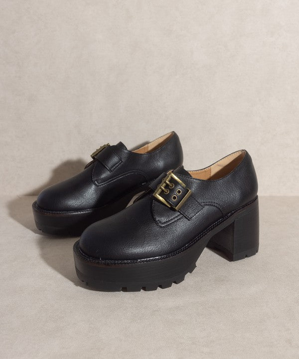 Black buckled platform loafers with e-inch heel, 1.5-inch front platform, and buckle closure.