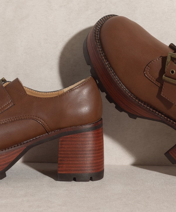 Brown buckled platform loafers with e-inch heel, 1.5-inch front platform, and buckle closure.