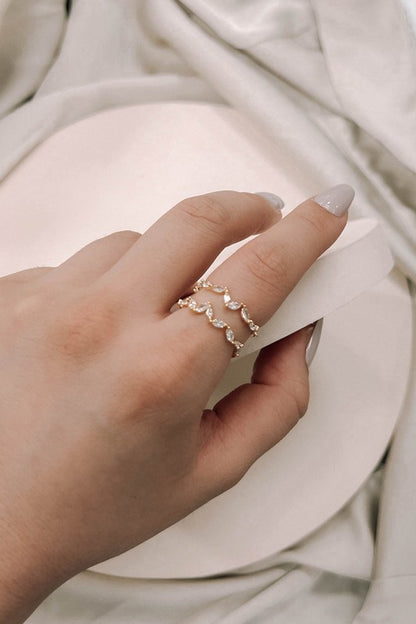 Woman wearing Stone Petal Double Layer Adjustable Ring in 18k gold plating with sparkling petal-shaped stones.