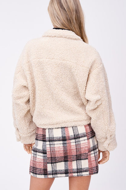 Back view of cream sherpa jacket showing relaxed fit and drop shoulders