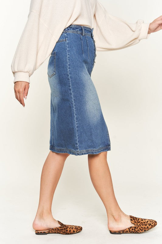 Denim button-down midi skirt with a front slit, belt loops, and back pockets. Features a high waist with an elasticized waistband in the back.