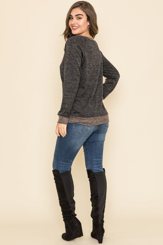 Casual black tunic with long raglan sleeves, round neck, and two-tone design.