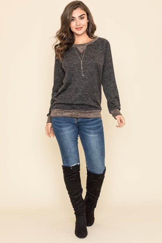 Casual black tunic with long raglan sleeves, round neck, and two-tone design.