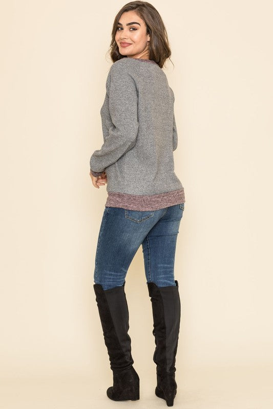 Casual charcoal tunic with long raglan sleeves, round neck, and two-tone design.