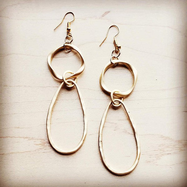 Matte gold hoop earrings with an oval hoop design, approximately 4" in length.