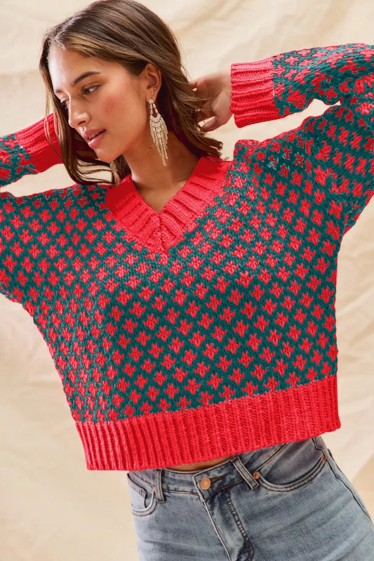 Model front view Chloe Color Block V Neck Sweater in hunter green and red with diamond knit pattern, long sleeves, ribbed trim.