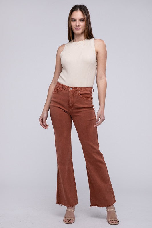 Rust acid-washed straight wide-leg pants featuring a frayed cutoff hem, zip fly closure, and a relaxed fit. Made with stretchy fabric for comfort and a unique vintage-inspired look.