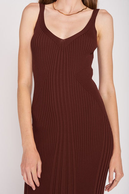 Detailed view of ribbed chocolate knit fabric and V-neckline with bodycon silhouette.
