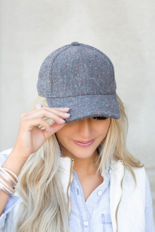 Woman wearing Faryn Fall Tweed Ball Cap in Gray highlighting tweed fabric and classic structured crown