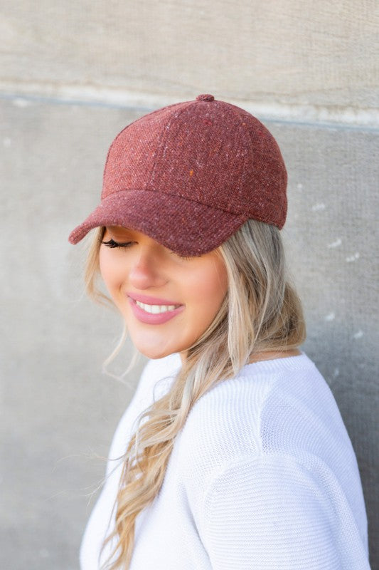 Woman wearing Faryn Fall Tweed Ball Cap in Rust with autumn-inspired hue and structured crown