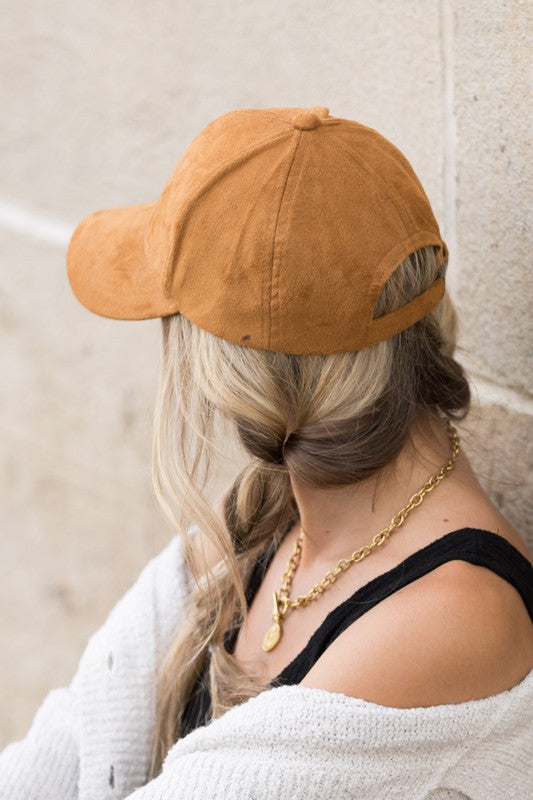 Back view of woman wearing Jaci Suede Boyfriend Ball Cap in Camel, adjustable silver clasp detail
