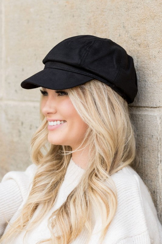 Woman wearing Gidget Suede Newsboy Cap in Black, classic newsboy style with faux suede finish