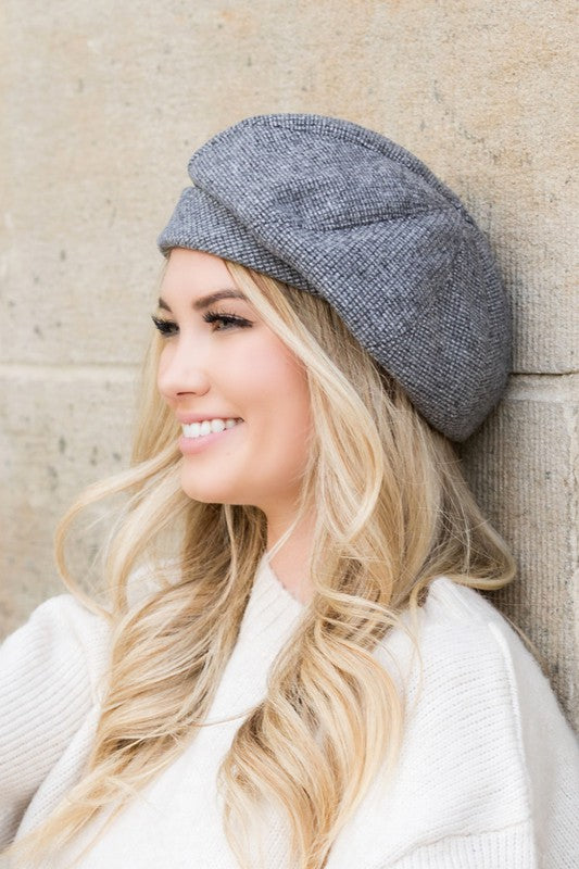Woman wearing gray Celine Fold Over Beret with slouchy fit and micro herringbone print.