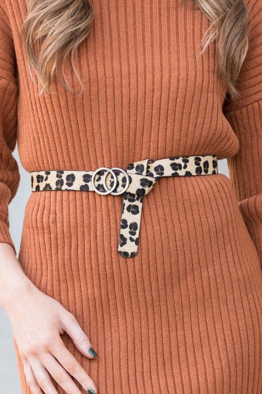 Woman wearing leopard Double O-Ring Belt with dress for a bold chic look.