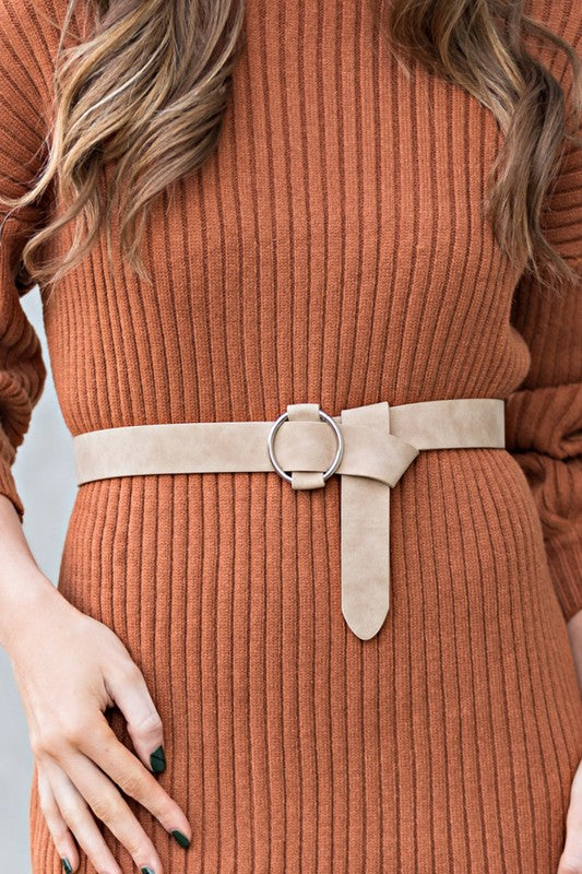 Cream vegan leather belt with silver O-ring buckle.