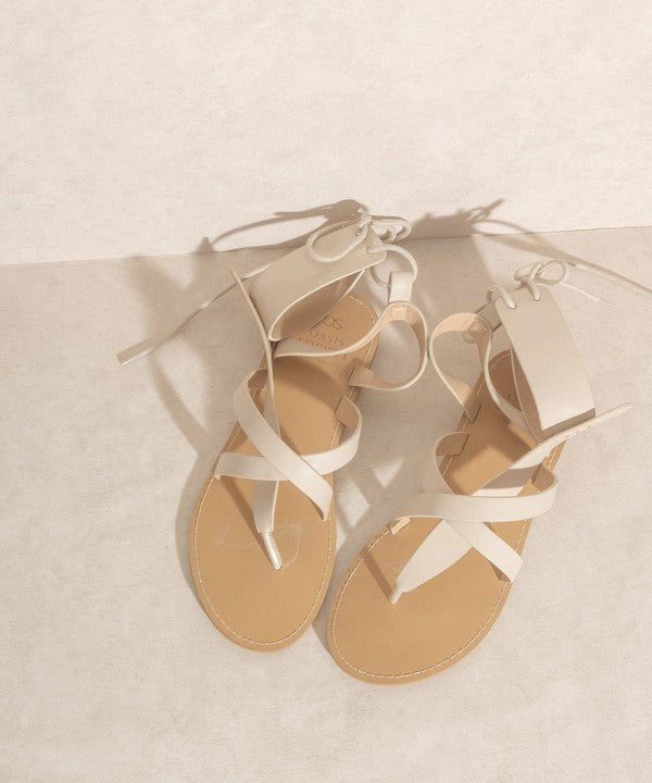 Beige boho-style lace-up ankle sandals.