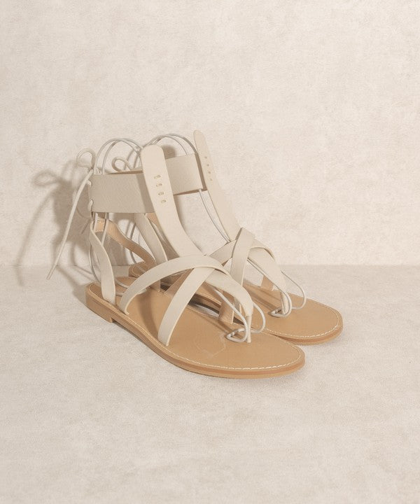 Beige boho-style lace-up ankle sandals.