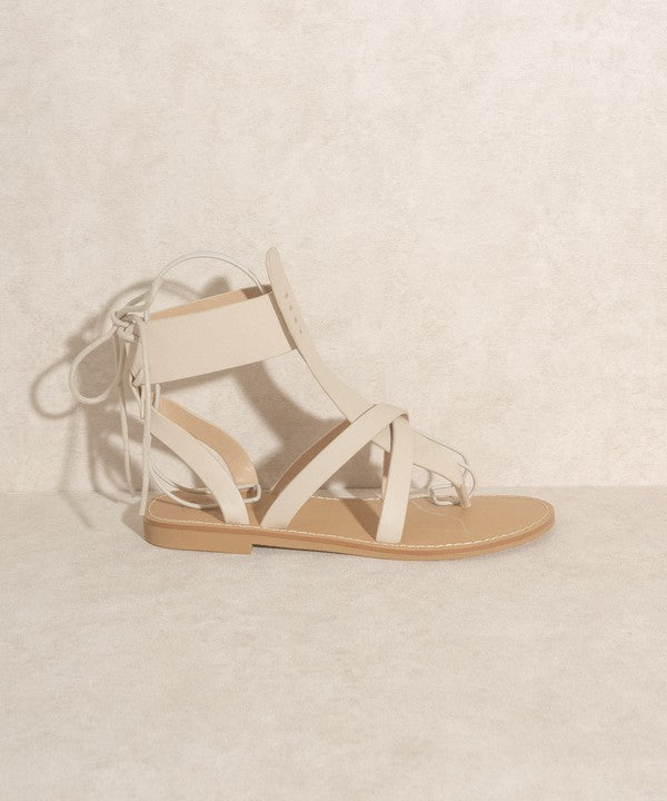 Beige boho-style lace-up ankle sandals.