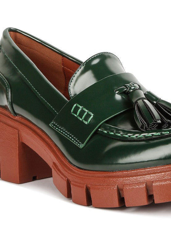 Close up of Jonah Platform Loafers in dark green showing tassel embellishment