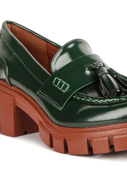 Close up of Jonah Platform Loafers in dark green showing tassel embellishment